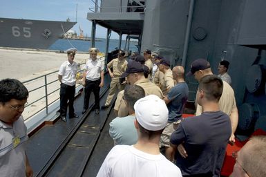 Russian Federation Navy (RFN) officers show American military around the Ship MARSHAL SHAPOSHNIKOV. The SHAPOSHNIKOV is one of four RFN ships and two US Navy (USN) ships participating off the coast of Guam (GU) in PASSEX 06, an exercise designed to increase interoperability between the two navies while enhancing the strong cooperative relationship between Russia and the United States