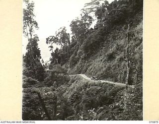 WAU - BULLDOG ROAD, NEW GUINEA, 1944-02-24. THE REINHOLD HIGHWAY AT ABOUT 6500 FEET ABOVE SEA LEVEL LOOKING TOWARDS WAU, APPROXIMATELY FOUR MILES IN THE DISTANCE