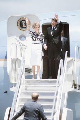 The President and Mrs. Ronald Reagan wave hello to the people waiting to greet them upon their arrival for a two day rest stop before continuing on to mainland China