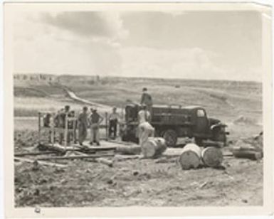 [Servicemen building field showers, Saipan]