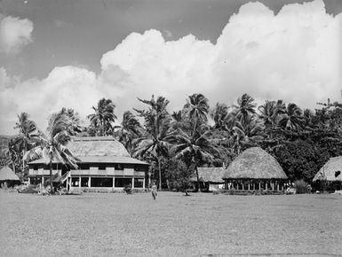 [Pacific Island view with many fale and Palm trees]