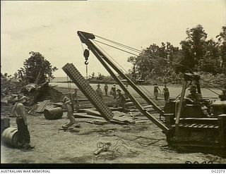 NEAR MAWARAKA, BOUGAINVILLE ISLAND, SOLOMON ISLANDS. C. 1945-02. MEMBERS OF THE AIF PUTTING THE FINISHING TOUCHES TO THE CONSTRUCTION OF VERNON FIELD. THIS AIRSTRIP, 900 FEET LONG BY 40 FEET, WAS ..