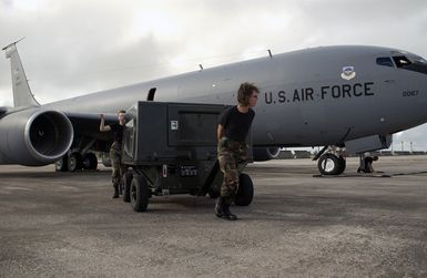 STAFF SGT. Jean Thomson, a crew chief augmentee with the 116th Air Refueling Squadron, Washington Air National Guard, based at Fairchild Air Force Base (AFB), Wash., moves an auxiliary power unit away from a KC-135 Stratotanker aircraft during their deployment at Andersen AFB, Guam, on Nov. 23, 2004. (USAF PHOTO by STAFF SGT. Bennie J. Davis III) (Released)