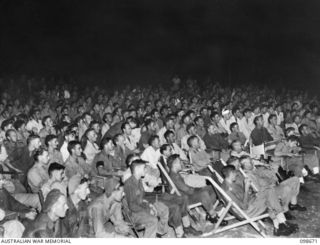 TOROKINA, BOUGAINVILLE. 1945-11-09. THE AUDIENCE VIEWED FROM THE SIDE OF THE STAGE, DURING THE LAST OF A SERIES OF CONCERTS PLAYED BY THE KOOKAROOS CONCERT PARTY AT 7 RAAF AIRFIELD CONSTRUCTION ..