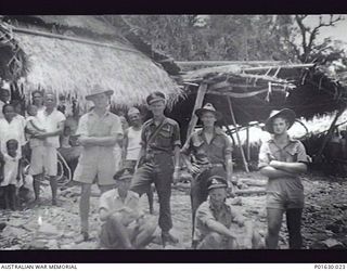 SAVO ISLAND. C.1944. CREW OF THE COMMANDING OFFICER OF NO 20 SQUADRON RAAF, COMMANDER A D WEARNE, IN A NATIVE VILLAGE. LEFT TO RIGHT, BACK ROW; BOB DRAPER; 2ND ENGINEER FRANK PARSONS; (POP); JIM ..