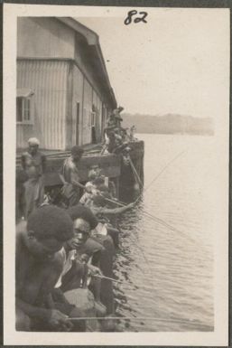 Men fishing from the pier, Rabaul, New Britain Island, Papua New Guinea, approximately 1916