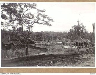 DREGER HARBOUR, NEW GUINEA. 1943-12-05. SLEEPING QUARTERS UNDER CONSTRUCTION OF THE 342ND UNITED STATES FIGHTER SQUADRON