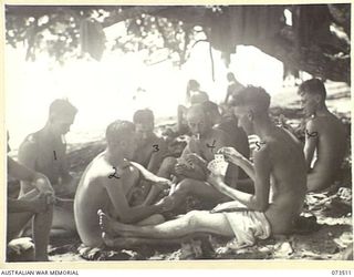 SARANG, NEW GUINEA. 1944-05-25. MEMBERS OF THE 35TH INFANTRY BATTALION PLAYING CARDS AT THE BEACH DURING A REST PERIOD IN THEIR MARCH ALONG THE COAST. IDENTIFIED PERSONNEL ARE:- NX120585 SERGEANT ..