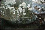 Man pointing at rock drawing