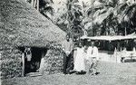 Reverend Billy and his wife with chief Henri Boula, in front of a hut