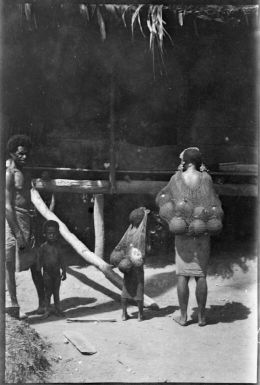 Woman and girl with bilums of coconut shells filled with water, Kila, Salamaua, New Guinea, 1933, 2 / Sarah Chinnery