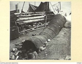 ORO BAY, NEW GUINEA. 1943-07. THE INCINERATOR FOR THE 10TH FIELD AMBULANCE, AUSTRALIAN ARMY MEDICAL CORPS WHICH HAS BEEN IMPROVISED FROM 44 GALLON DRUMS