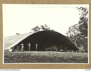 17 MILE, PORT MORESBY AREA, NEW GUINEA. 1943-12-13. ARMCO HUT WHICH HOUSES THE TENTAGE REPAIR SECTION OF THE RETURNED STORES DEPOT, 10TH AUSTRALIAN ADVANCED ORDNANCE DEPOT