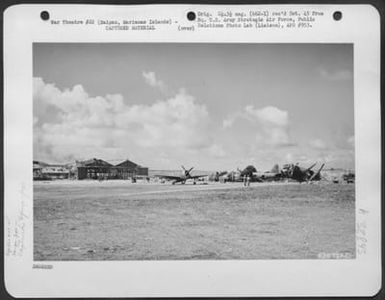 Republic P-47 'Thunderbolt' Sitting Beside Wrecked Japanese Betty'S And Hangars At An Airfield, Saipan, Marianas Islands. 23 June 1944. (U.S. Air Force Number 63671AC)