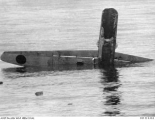 GUADALCANAL, SOLOMON ISLANDS, 1942-08-07. OFF TULAGI, A JAPANESE TORPEDO BOMBER SINKING INTO THE SEA AFTER ATTACKING UNITED STATES DESTROYERS