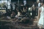 Artist on school house steps, Society Islands, surrounded by crowd