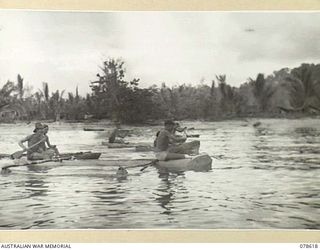 SWAN BEACH, NEW BRITAIN. 1945-01-27. COMPETITORS LINING UP AT THE STARTING TAPE FOR THE HEAD OF THE BAY BOAT RACE AT THE 13TH INFANTRY BRIGADE SWIMMING CARNIVAL. THE EVENT WAS WON BY LANCE CORPORAL ..