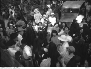 Ramale Mission, Kokopo Area, New Britain. The farewell scene as twenty of a group of 158 white former internees leave Ramale Mission for evacuation to Rabaul to receive medical treatment at 4 Field ..