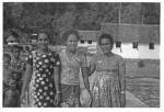 Female group and children in front of houses