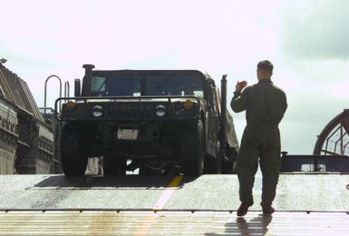 Crewmembers of the Landing Craft, Air Cushioned (LCAC) 57 offloads an M998 High-Mobility Multipurpose Wheeled Vehicle (HMMWV) on the Inner Apra Harbor, Guam, in support of Exercise TANDEM THRUST 2003