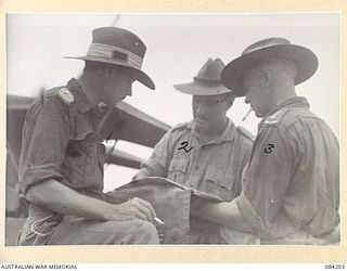 SUAIN PLANTATION, NEW GUINEA. 1944-12-08. BRIGADIER J.E.G. MARTIN, AND 19 INFANTRY BRIGADE (1), STUDYING THE BATTLE MAP WITH CAPTAIN E.A. SMITH, COMMANDER A COMPANY, 2/4 INFANTRY BATTALION, (2), ..