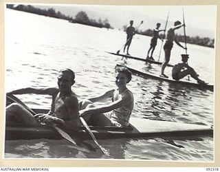 JACQUINOT BAY, NEW BRITAIN, 1945-05-20. PRIVATE J. MORRIS (1), AND CORPORAL N. BURCHELL, AUSTRALIAN ARMY MEDICAL WOMEN'S ASSOCIATION (2), WINNERS OF THE MIXED DOUBLES SEA SKI EVENT AT THE GRAND ..