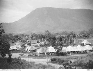 THE SEVENTEEN MILE, PORT MORESBY, NEW GUINEA. 1943-07-03. GENERAL VIEW OF THE 2/9TH AUSTRALIAN GENERAL HOSPITAL AND THE 166TH STATION HOSPITAL, UNITED STATES FORCES, WITH HOBRUM'S BLUFF IN THE ..