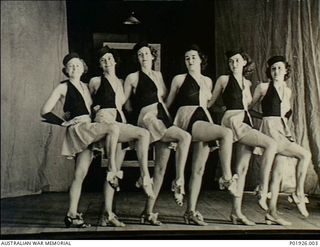 Port Moresby, Papua. 1940-09-12. Some of the cast of the amateur Sunny Side Up Company patriotic concert party, providing entertainment in aid of the Red Cross, on stage following a performance at ..