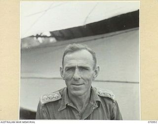 WAU - LAE ROAD, NEW GUINEA, 1944-03-10. NG3501 CAPTAIN J.W. ECCLESTONE, OFFICER COMMANDING LABU - MARKHAM POINT SECTION. CAPTAIN ECCLESTONE WAS RESPONSIBLE FOR LOCATION OF THE BULLDOG ROAD FROM ..