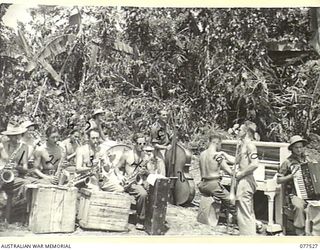 BOUGAINVILLE ISLAND. 1944-12-07. MEMBERS OF THE SWING BAND OF THE "TASMANIACS" - THE TASMANIA LINES OF COMMUNICATION CONCERT PARTY REHEARSING IN A JUNGLE CLEARING FOR THE EVENING PERFORMANCE. ..