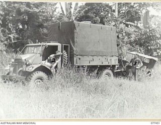 LAE BASE AREA, NEW GUINEA. 1944-12-04. TX14492 CRAFTSMAN R.G. SPEARS (1) AND TX13687 CRAFTSMAN W.A. HODGE (2) RECOVERY CREW OF THE 2/77TH LIGHT AID DETACHMENT LIFTING A JEEP IN PREPARATION FOR ..