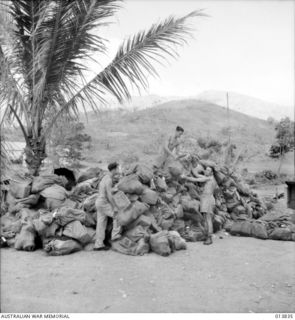 1942-12-14. NEW GUINEA. FIRST BATCH OF CHRISTMAS PARCELS ARRIVE AT THE ARMY BASE POST OFFICE FOR DISTRIBUTION TO THE VARIOUS UNITS. (NEGATIVE BY G. SILK)