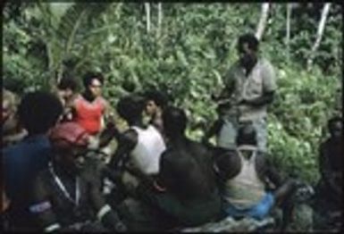 Men sitting on rocks for some kind of meeting, and shots of the surrounding gardens