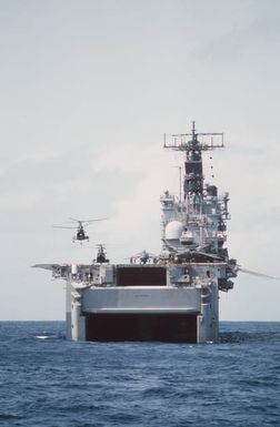 A CH-46E Sea Knight helicopter of Marine Medium Helicopter Squadron 261 (HMM-261) lifts off the flight deck of the amphibious assault ship USS SAIPAN (LHA 2) as an AV-8B Harrier aircraft is readied for takeoff during Operation Sharp Edge. Marines of the 22nd Marine Expeditionary Unit (22nd MEU) are being sent to the U.S. Embassy in Monrovia, Liberia, to augment security and evacuate U.S. and foreign nationals from the fighting between government and rebel forces