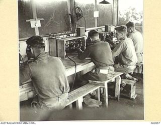 DUMPU, NEW GUINEA. 1944-01-11. THE CENTRAL WIRELESS TELEPHONE RECEIVING HUT OF THE 7TH DIVISION SIGNALS, SHOWING THE ARRANGEMENT OF THE NO. 4 AUSTRALIAN RECEIVERS