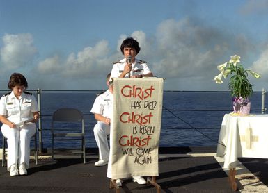 CDR. Jane F. Vieira, CHC conducts the Easter Sunrise Service on the fantail of the submarine tender USS HOLLAND (AS-32) while the ship is en route from Guam to Sasebo, Japan