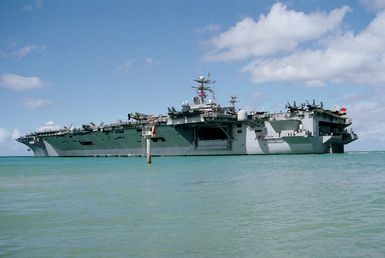 Port quarter view of the nuclear-powered aircraft carrier USS ABRAHAM LINCOLN (CVN 72) passing the Pearl Harbor channel marker as the ship puts to sea to take part in Operation RIMPAC 2000