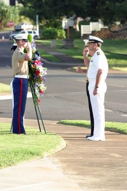 Two wreath bearers one US Marine Corps (USMC) Marine and one US Navy (USN) Sailor salute the General Officers before staging the memorial wreath at the Kaneohe Klipper Ceremony, on December 7, 2004, at Marine Corps Base Hawaii (MCBH) Kaneohe Bay