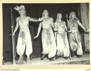 PORT MORESBY, NEW GUINEA. 1944-04-26. MEMBERS OF THE "DIGGER DANDIES" CONCERT PARTY, QUEENSLAND LINES OF COMMUNICATION AREA, REVIVE MEMORIES OF THE MIDDLE EAST WHILE THEY PERFORM AN EGYPTIAN SONG ..