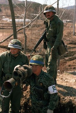 Members of the 25th Infantry Division from Schofield Barracks, Hawaii, and a member of the 2nd Republic of Korea Tank Battalion pinpoint the location of Orange Forces using the sight mechanism on an M-47 Dragon anti-tank weapon during the joint Republic of Korea/U.S. training Exercise Team Spirit '82