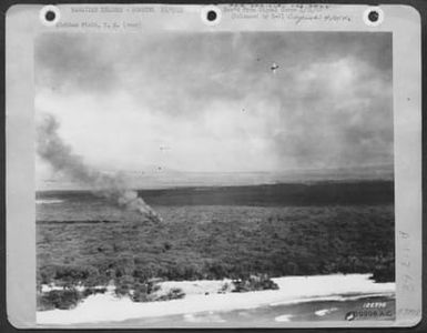 Hawiian Islands - Bombing 12/7/41. Hickam Field, T.H. One Of The First Army Photos Of The Bombing Of Hickam Field, Hawaii, Dec. 7 1941. Unidentified Planes Circle In Combat. (U.S. Air Force Number 59998AC)