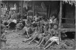 Mortuary ceremony: women, most wearing fiber skirts, gathered for exchange