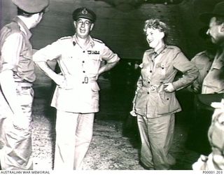 THE SOLOMON ISLANDS, 1945-08. TWO ARMY OFFICERS WITH BRITISH ENTERTAINER GRACIE FIELDS AFTER A THANKSGIVING SERVICE ON BOUGAINVILLE ISLAND. (RNZAF OFFICIAL PHOTOGRAPH.)