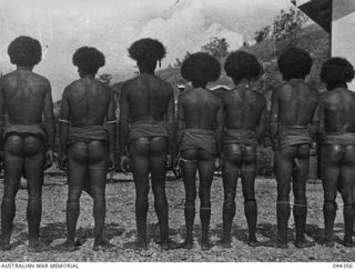 PAPUA NEW GUINEA - PROBABLY NORTHERN PROVINCE, LATE 1942 OR EARLY 1943. VILLAGERS PHOTOGRAPHED AFTER BEING BEATEN (THEY CLAIM) BY MEMBERS OF THE AUSTRALIAN ARMY. (PHOTOS LENT FOR COPYING BY HANK ..