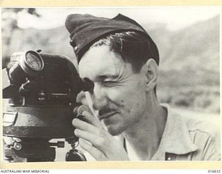 NEW GUINEA. 3 MARCH 1944. A CLOSE UP VIEW OF SERGEANT JACK MADDEN OF STANMORE, SYDNEY, NSW, OF THE METEOROLOGICAL SECTION WITH WIND VELOCITY INSTRUMENT TAKING READINGS AT AN ADVANCED AIRSTRIP. THE ..
