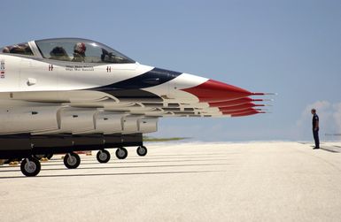 U.S. Air Force TECH. SGT. Brian Plauche, a Crew CHIEF assigned to the U.S. Air Force Thunderbirds Aerial Demonstration Team, marshals the F-16C Fighting Falcon aircraft into position, after the Team Landed at Andersen Air Force Base, Guam, September 9, 2004. This landing marks the first time in a decade the USAF Thunderbird demonstration team has visited Guam. The Thunderbirds will be performing during an air show held Sunday, September 12, 2004. (U.S. Air Force PHOTO by STAFF SGT. Bennie J. Davis III) (Released)