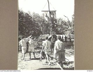 1942-11-19. NEW GUINEA. KOKODA. BEING WOUNDED BROUGHT IN TO A HOSPITAL AT KOKODA. (NEGATIVE BY G. SILK)