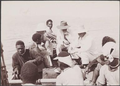 Men in boat going ashore at Rowa, Banks Islands, 1906 / J.W. Beattie