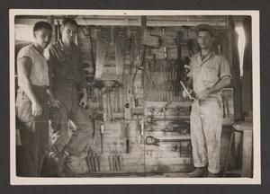 [Men Standing in Front of Hanging Tools]