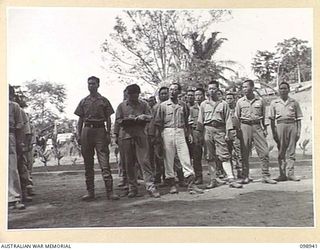 NAMANULA, NEW BRITAIN, 1945-11-21. A GROUP OF KOREAN OFFICERS LISTENING TO MAJ-GEN K.W. EATHER, GOC 11 DIVISION. MAJ-GEN EATHER SUMMONED THEM TO DIVISION HQ TO INFORM THEM OF THE ARRANGEMENTS MADE ..